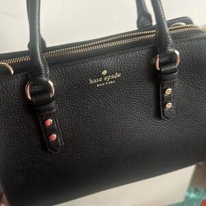 This is a Kate Spade handbag  in the color black